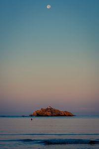 Scenic view of sea against sky at sunset