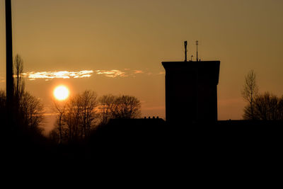 Silhouette building against sky during sunset