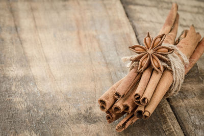 Bundle of cinnamon with star anise on table