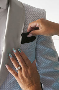 Cropped hands of woman adjusting pocket square