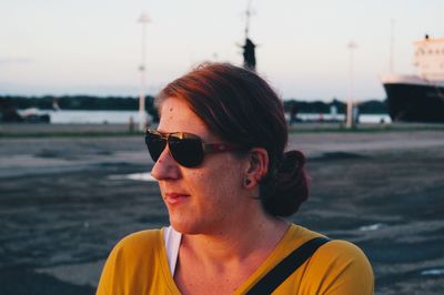 Close-up of man wearing sunglasses against sky