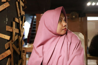 Young woman wearing hijab looking away