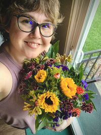 Portrait of young woman with flowers