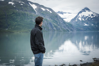 Rear view of man standing in lake