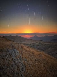 Scenic view of landscape against sky at night