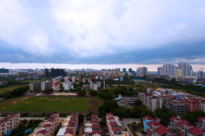 Buildings against cloudy sky