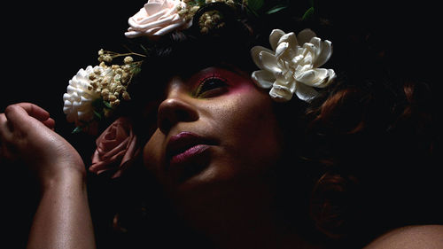 Close up of woman with makeup flowers on her head grungy portrait light manipulation beauty portrait