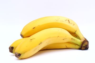 Close-up of yellow fruit against white background