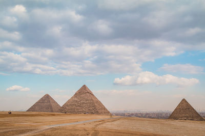 Pyramids against cloudy sky