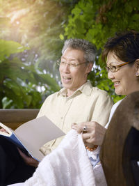 Man with woman reading book