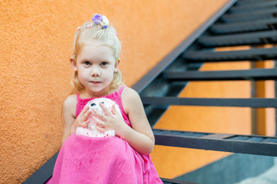 Portrait of cute girl looking away while standing outdoors