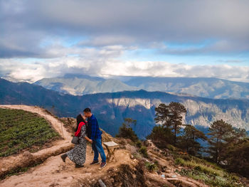 Full length of man standing on mountain against sky