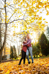 Full length of woman with umbrella during autumn