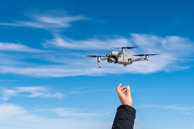 Low angle view of airplane flying against sky