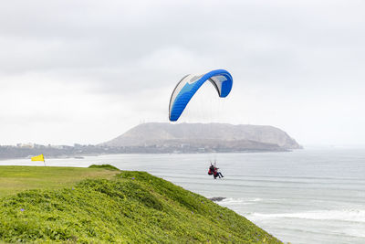 Scenic view of person riding on land against sky