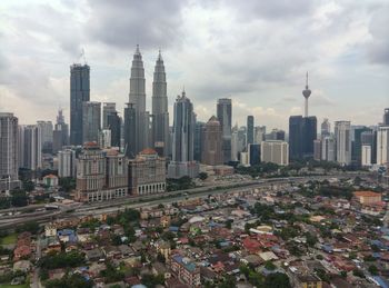 View of skyscrapers against cloudy sky