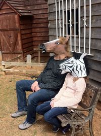 Full length of woman sitting on bench