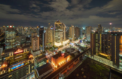 High angle view of illuminated buildings in city at night