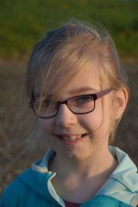 Close-up portrait of smiling girl outdoors