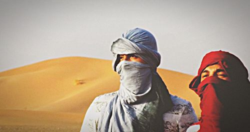 Midsection of man wearing hat against clear sky