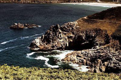 High angle view of rocks at sea shore