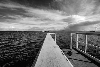 Pier over sea against sky