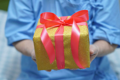 Close-up of hand holding red box