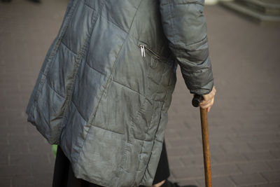 Low section of man standing on footpath