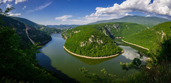 High angle view of lake amidst mountains against sky