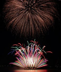 Low angle view of firework display at night