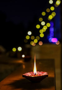 Close-up of illuminated candles on fire