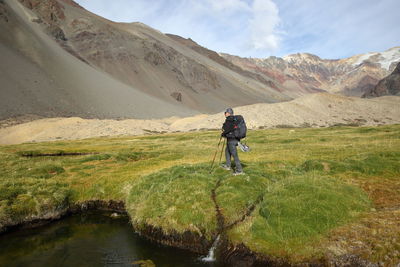 Rear view of man walking on mountain