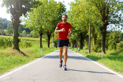 Full length portrait of man running on road