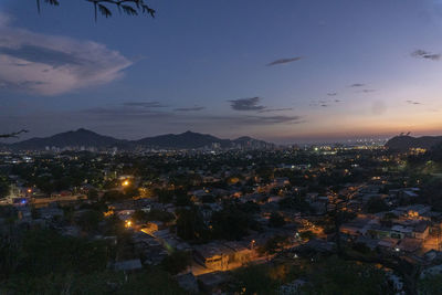 High angle view of illuminated buildings in city at night