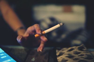 Close-up of woman holding cigarette