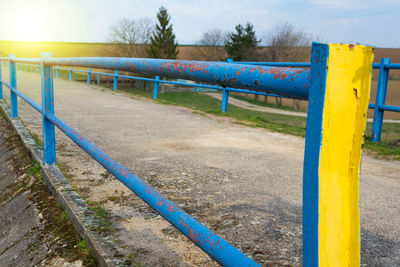 Metal fence against blue sky