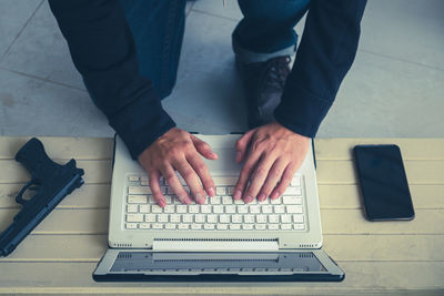 High angle view of man using laptop on table