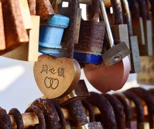 Close-up of love padlocks on railing