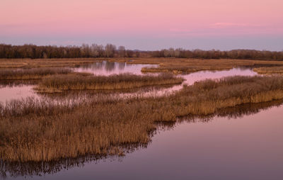 Scenic view of lake against sky during sunset