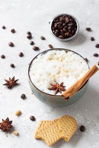 Cappuccino decorated with anise star and cinnamon stick with gingerbread cookies. 