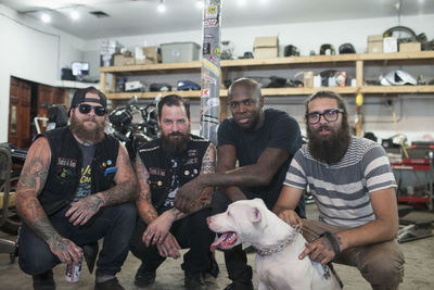 A group of young men with a dog.