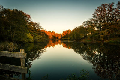 Reflection of trees in lake against sky