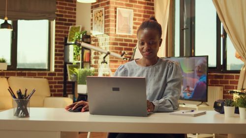 Young woman using laptop at table