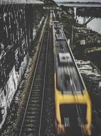 Railroad tracks in city against sky