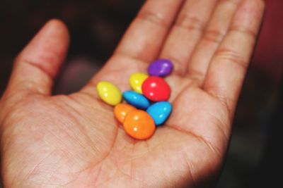 Close-up of hand holding multi colored finger