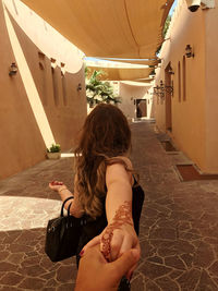 Rear view of woman walking in building