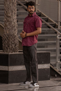 Full length of young man standing on steps