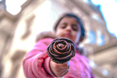 Close-up of girl holding chocolate