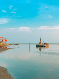 Fishing boat in sea against sky