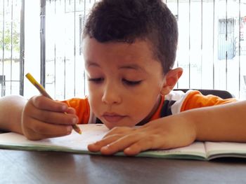 Boy painting on book, studying